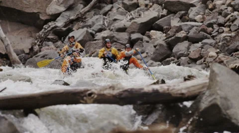 Whitewater Rafters Paddling Down Crazy Rapids With Large Splashes Stock Footage 64309111