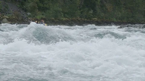Whitewater rafters paddling through rapids on a river in Patagonia Chile Stock Footage 70452275