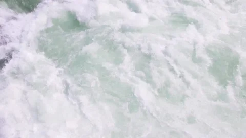 Whitewater rapids at first before panning up to towering mountains and forest Stock Footage 140609801