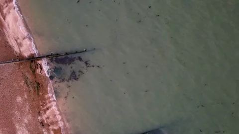 Whitstable Harbour - overhead view moored boats and waves hitting coastline Stock Footage 251630223