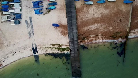 Whitstable Harbour - overhead view moored boats and waves hitting coastline Stock Footage 251630590