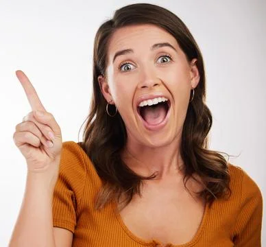 Who knows the answer to this question. Studio shot of a young woman pointing in Stock Photos