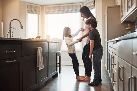 Who needs a dance floor when youve got a kitchen. a happy mother playing with Stock Photos