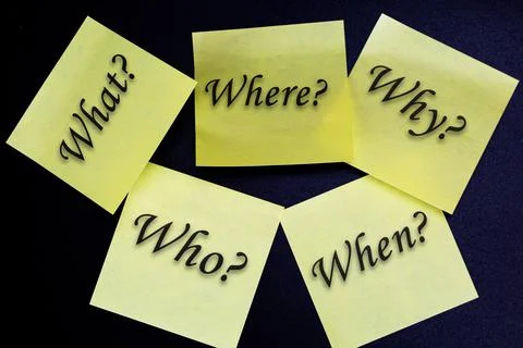 Who, why, what, when and where written on yellow sticky notes on black Stock Photos