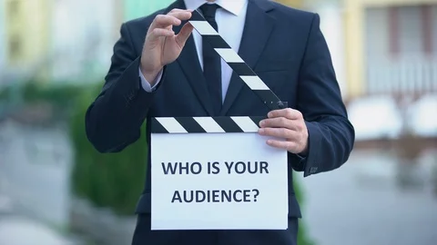 Who is your audience question on clapperboard in hands of male celebrity, pr Stock Footage 113479196