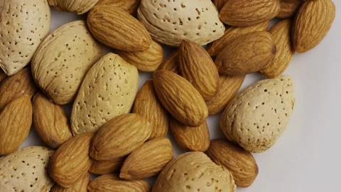 Whole almonds in shell rotating on white background surface Stock Footage 327829646