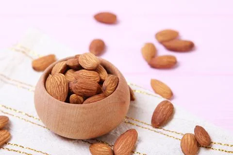 Whole almonds on the table. Stock Photos