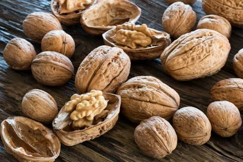 Whole and broken walnuts on old wood Stock Photos