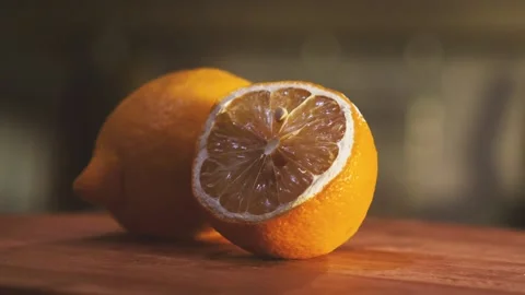Whole and cut in half lemons lie on the kitchen board Video stock 160708941