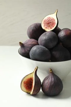 Whole and cut tasty fresh figs on white table Stock Photos