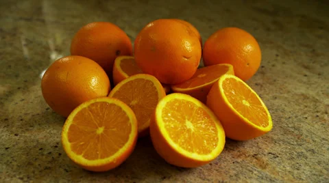 Whole and Sliced Oranges on Counter, Close Up Stock Footage 35224089