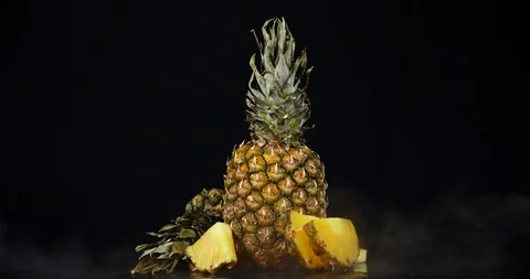 Whole and slices of pineapple with cool steam. Stock Footage 129802443