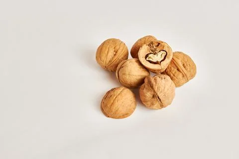 Whole and split walnuts on a white background. Stockfoto's