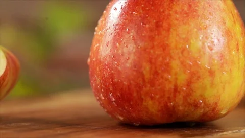 Whole Apple and Apple Slice Rotating Closeup Stock Footage 99137673