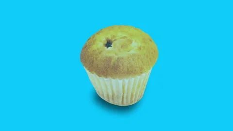 Whole baked muffin in paper form slides from right to left and disappears on Stock Footage 99791007
