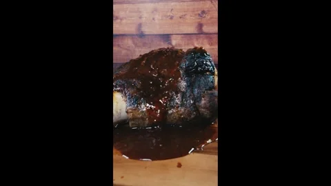 Whole Beef Shin with Bone and Gravy on Board Stock Footage 325116761