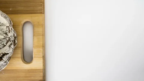 Whole bread on a cutting board, stop motion animation on white background 4k Stock Footage 129034224