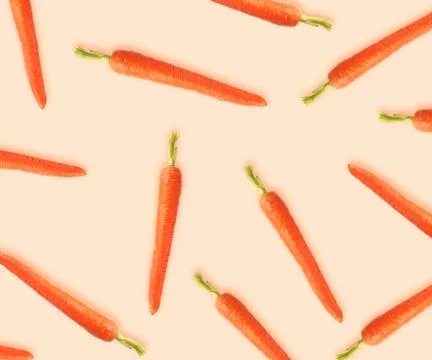 Whole carrots on beige background. Pattern design 스톡 사진