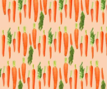 Whole carrots on beige background. Pattern design Stockfoto's