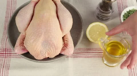 A whole chicken being brushed with melted butter Stock Footage 24671257