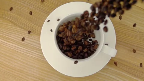 Whole Coffee Beans  Falling into the Cup. Stock Footage 75659995