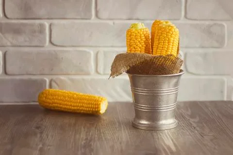 Whole corn  on gray table. Stock Photos