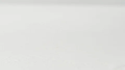 Whole cucumber splits into pieces while flying on a white surface in slow motion Stock Footage 92906582