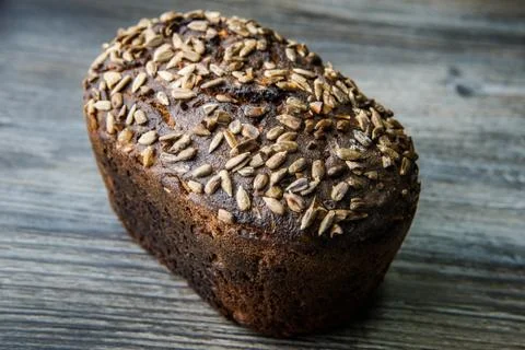 Whole delicious homemade rectangular rye bread with sunflower seeds on top li 스톡 사진