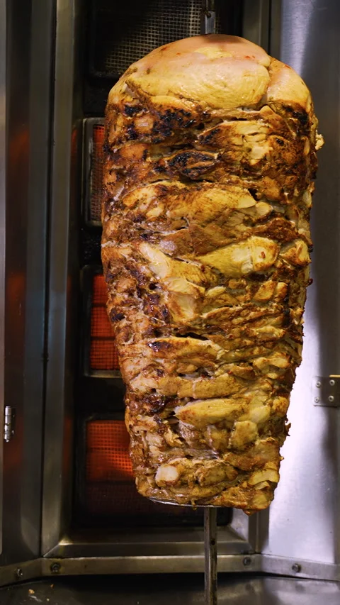 Whole Doner Kebab Stack Roasting on Vertical Grill Stock Footage 311485053