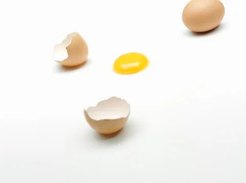 A whole egg, an egg shell and an egg yolk Stock Photos