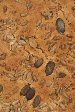 Whole grain bread crust with seeds background texture Stock Photos