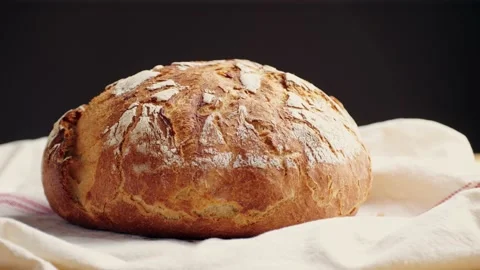 Whole grain bread put on kitchen wood plate by the chef in bakery. Fresh bread Stock Footage 232413017