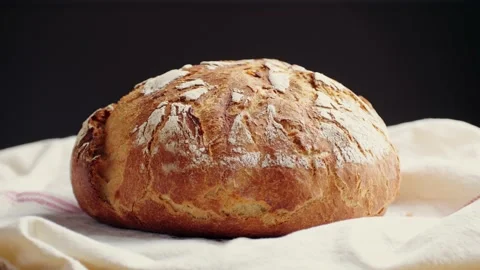 Whole grain bread put on kitchen wood plate by the chef in bakery. Fresh bread Stock Footage 233271324