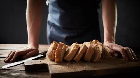 Whole grain bread put on a kitchen plate with a chef, Stock-Fotos