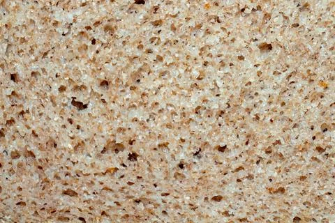 Whole grain bread texture background with natural holes and crumbs for health 库存照片