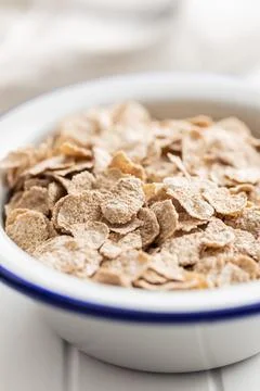 Whole grain cereal flakes. Wholegrain breakfast cereals in bowl on kitchen ta Stock Photos