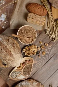 Whole grain multigrain bread, whole and sliced, contains seeds isolated on black Stock Photos
