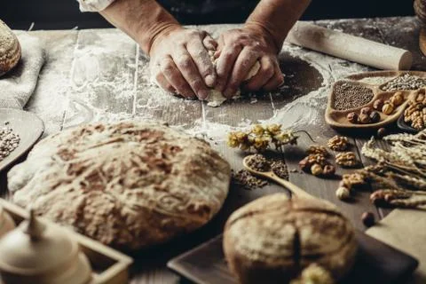Whole grain multigrain bread, whole and sliced, contains seeds isolated on black Stock Photos