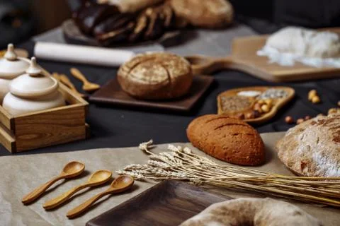 Whole grain multigrain bread, whole and sliced, contains seeds isolated on black Stock Photos