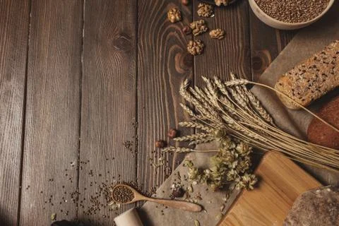 Whole grain multigrain bread, whole and sliced, contains seeds isolated on black Stock Photos