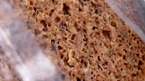 Whole grain rye German bread in an open plastic package Stock Footage 331802988