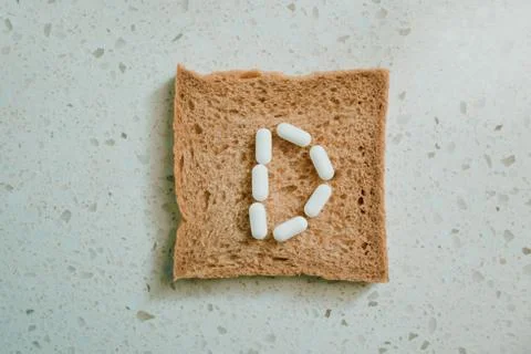 Whole grain slice of bread with D letter as "diet" Stock Photos