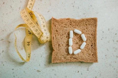Whole grain slice of bread with D letter as "diet" Stock Photos