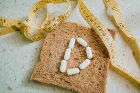 Whole grain slice of bread with D letter as "diet" Stock Photos