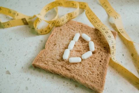 Whole grain slice of bread with D letter as "diet" Stock Photos