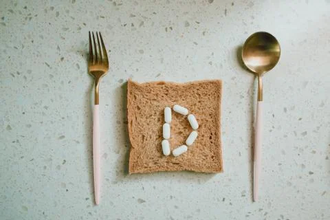 Whole grain slice of bread with D letter as "diet" Stock Photos