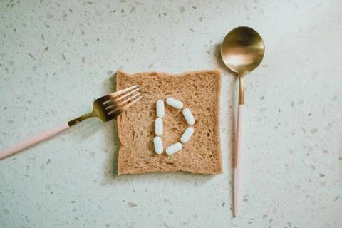 Whole grain slice of bread with D letter as "diet" Stock Photos