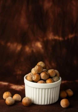 Whole hazelnuts on a brown background Stock Photos