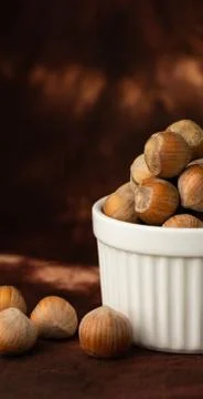 Whole hazelnuts on a brown background Stock Photos