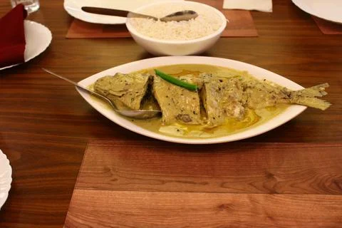 Whole Hilsa Fish cooked with mustard gravy Stock Photos